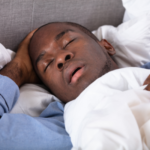 Man sleeping with mouth open, a common sign of obstructive sleep apnea
