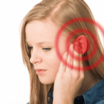 oung woman holding her ear with red rings showing ear pressure from sinus problems